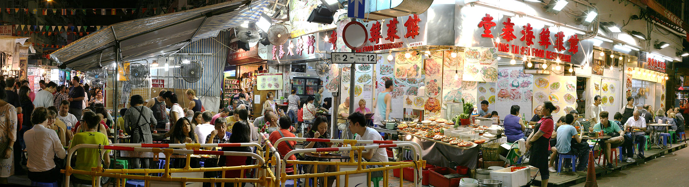 Nighttime Photo Panoarama of Outdoor Restaurant in Hong Kong.